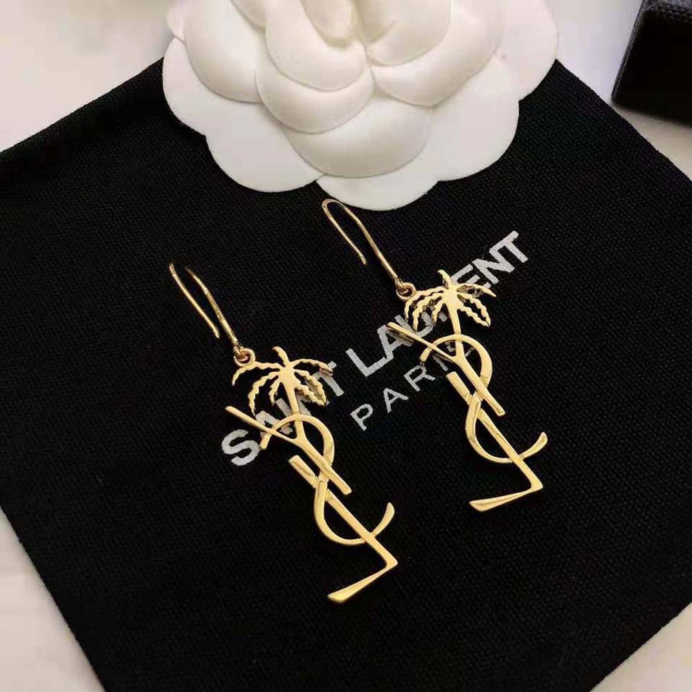 Close-up on signature YSL logo detail of Cassandre Palm Earrings
