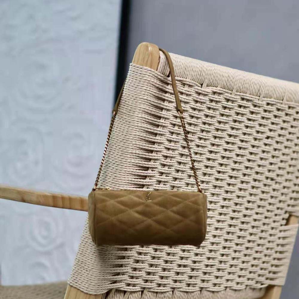 Close-up of gold YSL hardware on green quilted suede bag