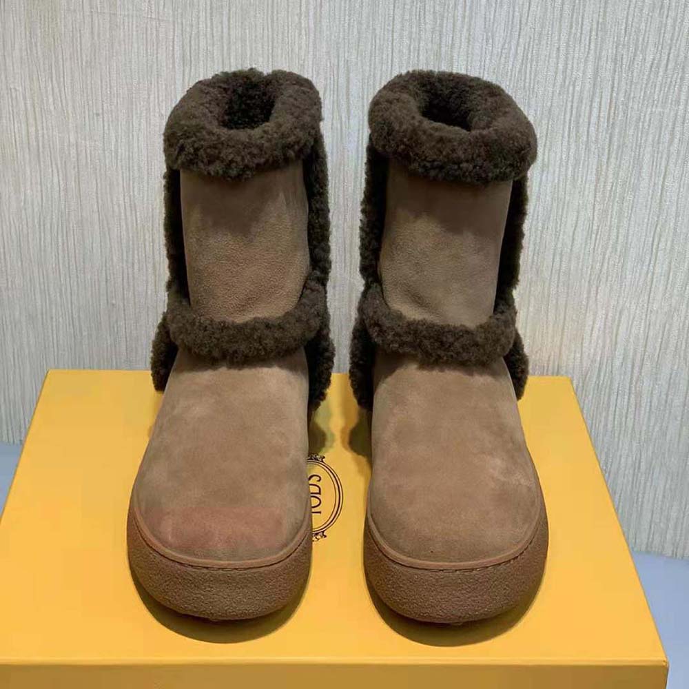 Close-up of suede texture and lace detail on TODS ankle boots