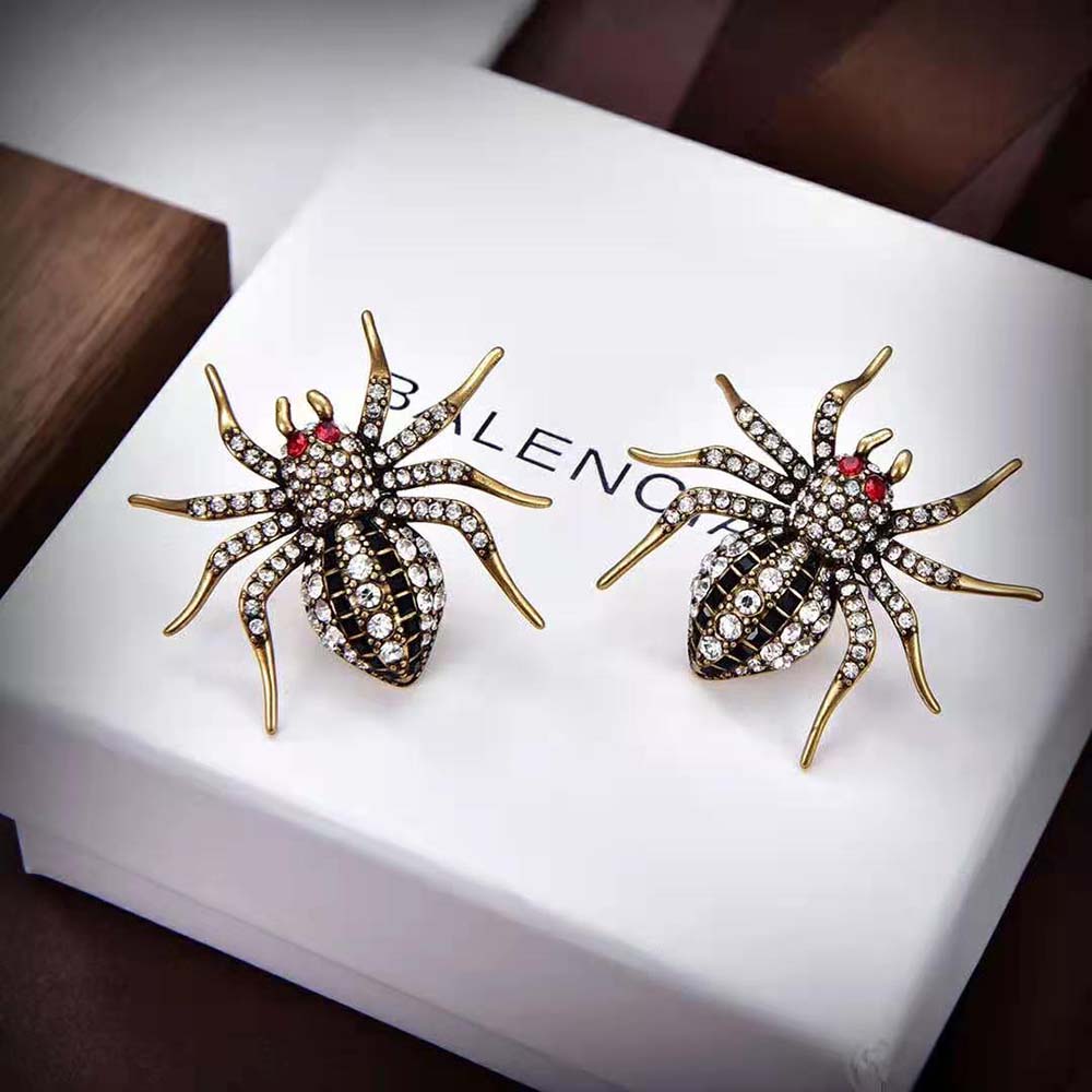 Side view of Balenciaga Women Goth Spider Earrings in Grey on ear model