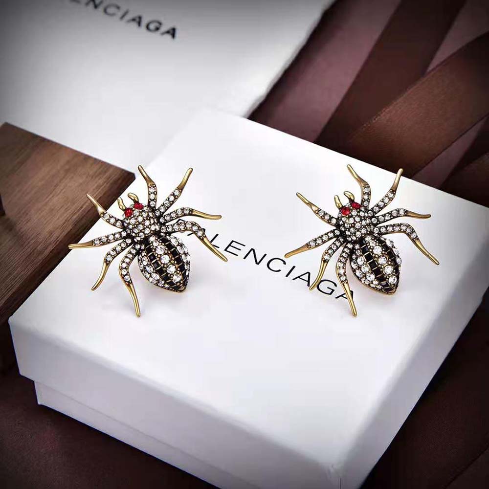 Balenciaga Women Goth Spider Earrings in Grey displayed against black background