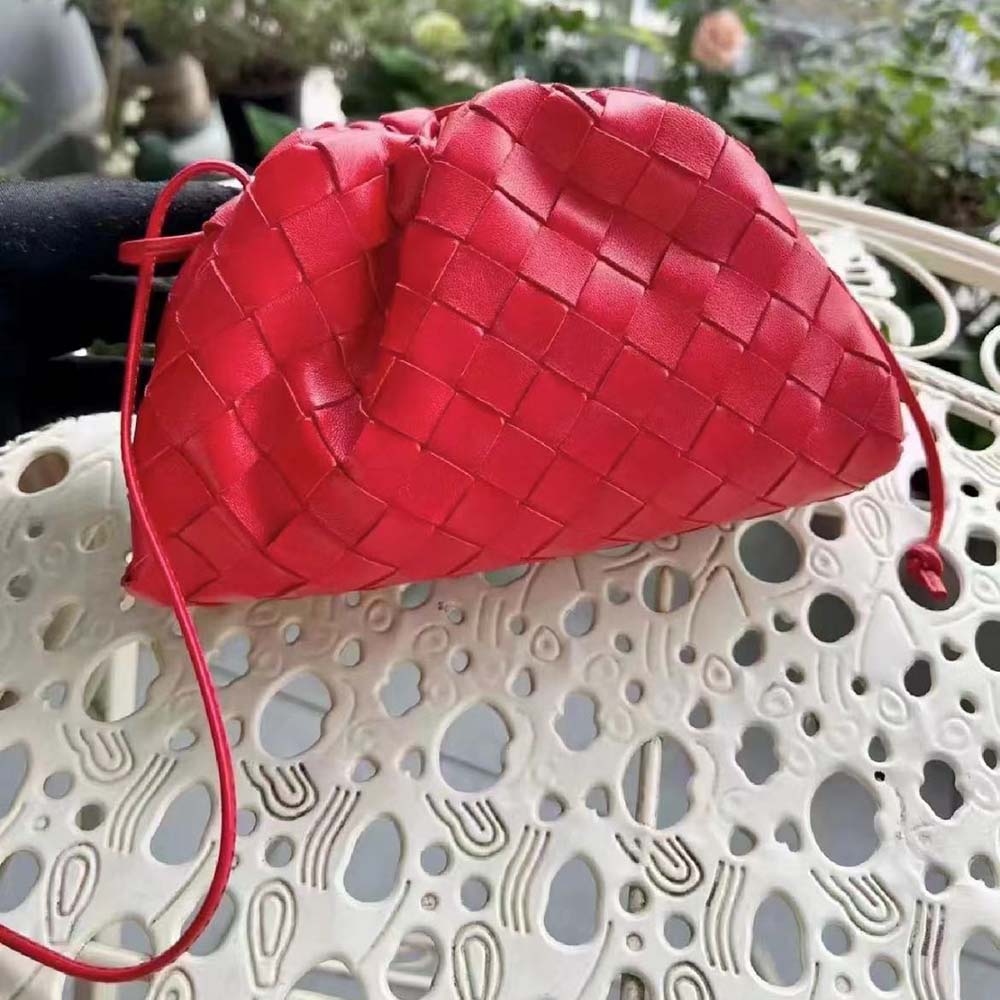 Side angle showing the voluminous silhouette of the Bottega Veneta Red Mini Pouch