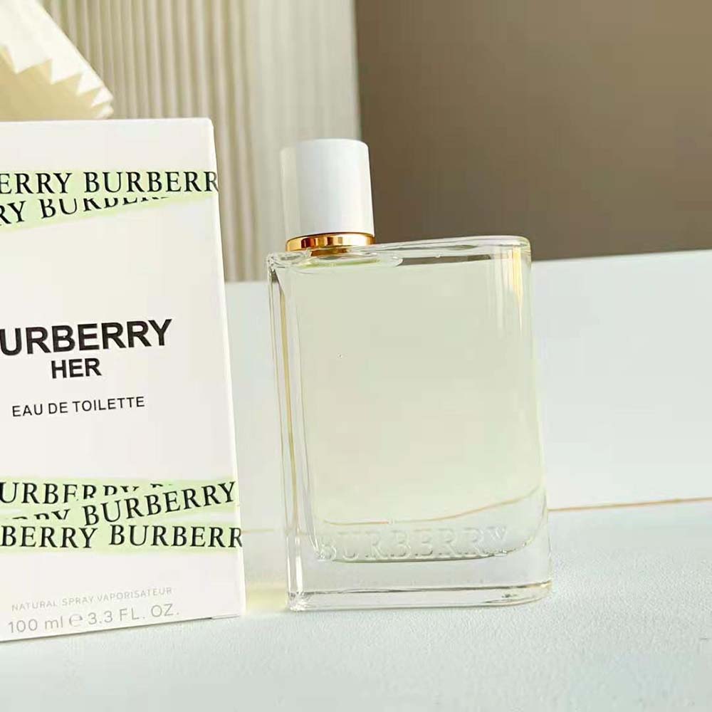 Angled shot highlighting green glass and logo on Burberry Women Her Eau de Toilette