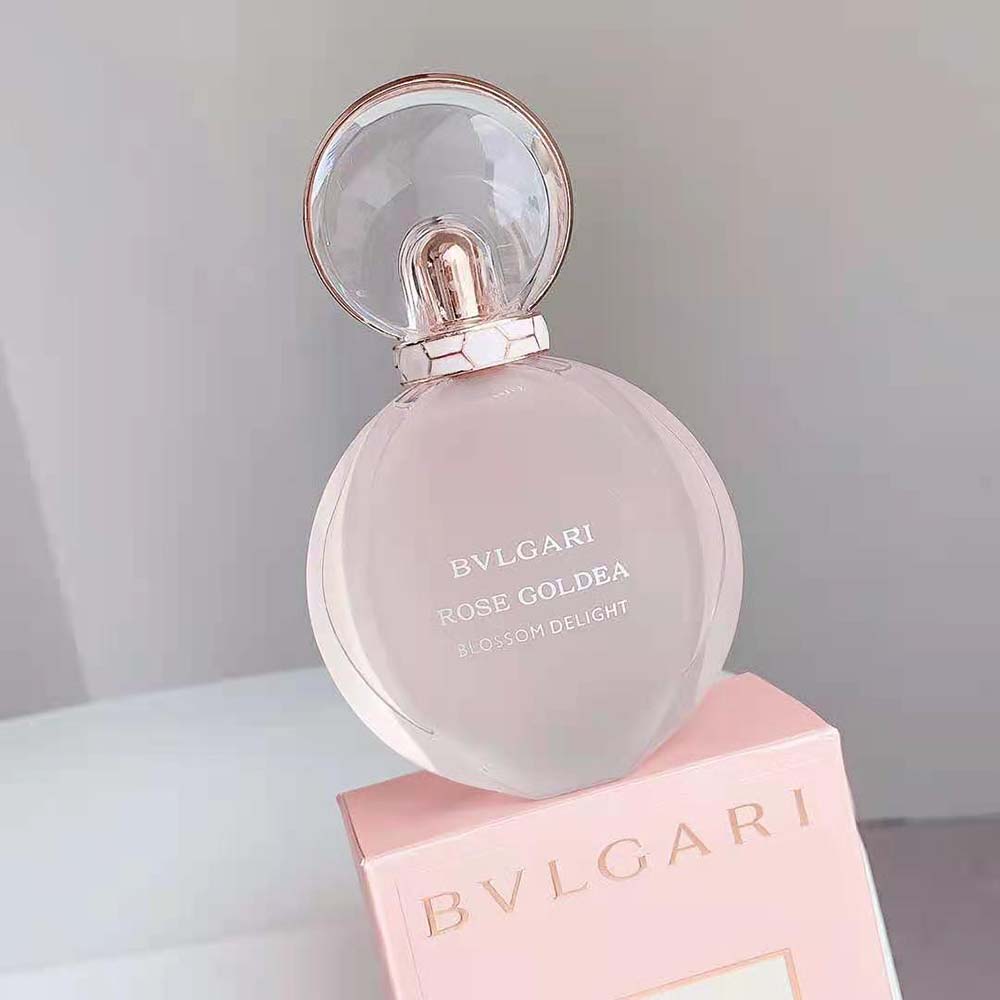 Side angle showing delicate glass and pink tint of fragrance bottle
