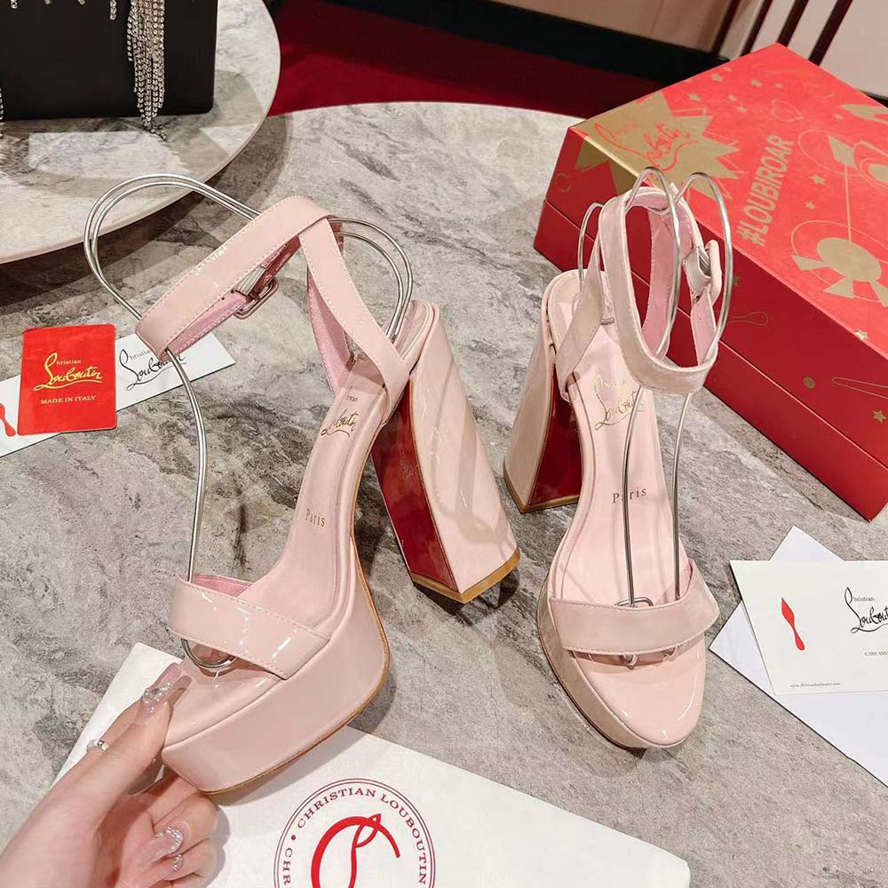 Close-up of beige leather straps and signature red sole of Movida Sabina sandals