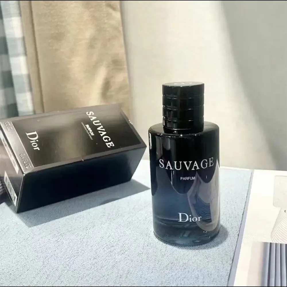Top-down view highlighting embossed Dior logo on Sauvage Parfum bottle