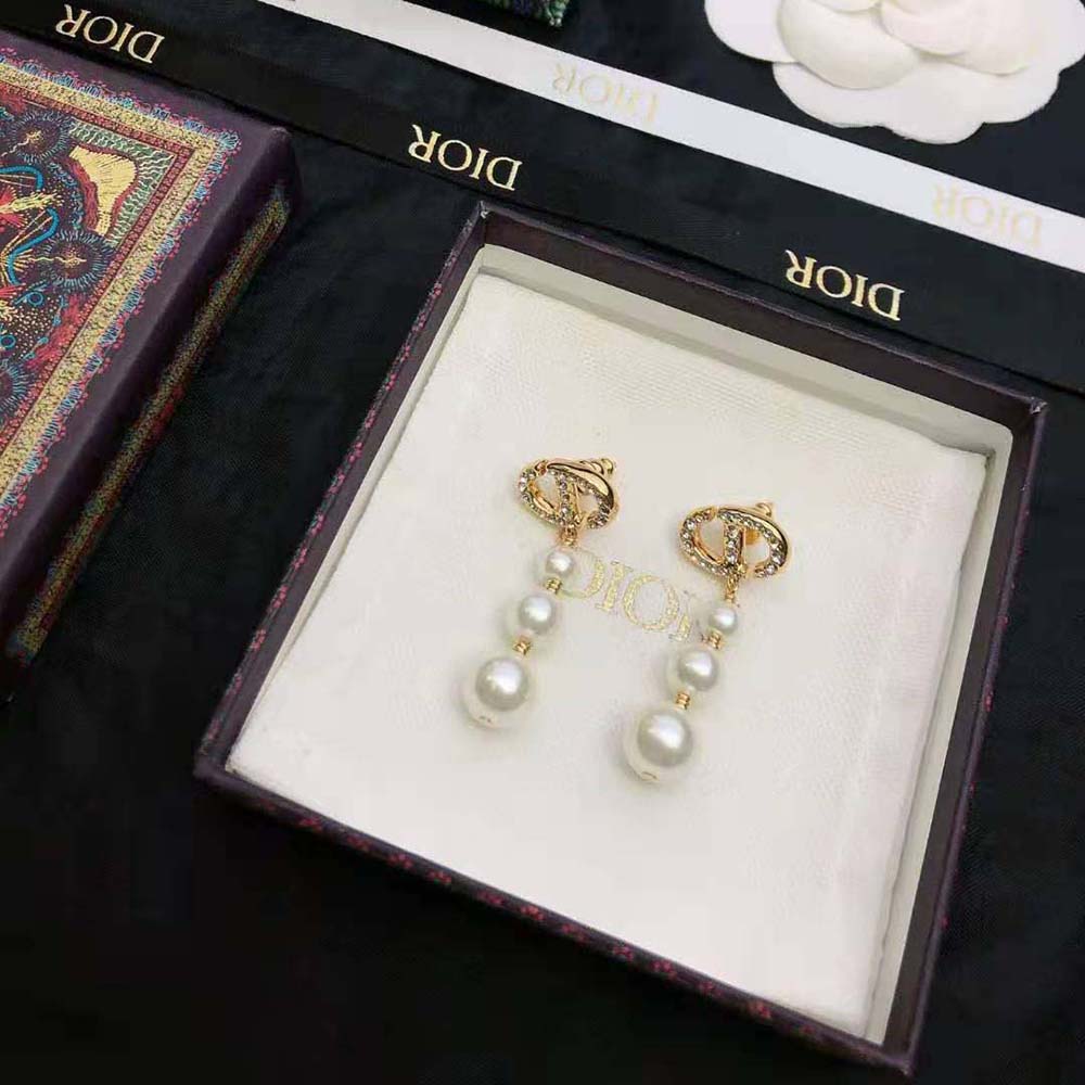 Side angle showing the white resin pearls on Dior Women CD Navy Earrings