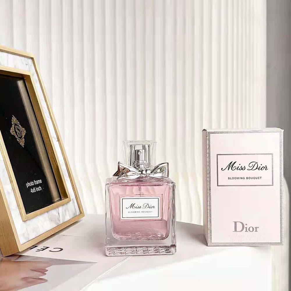 Close-up of pink glass and signature logo on Dior Women Miss Dior Eau de Toilette