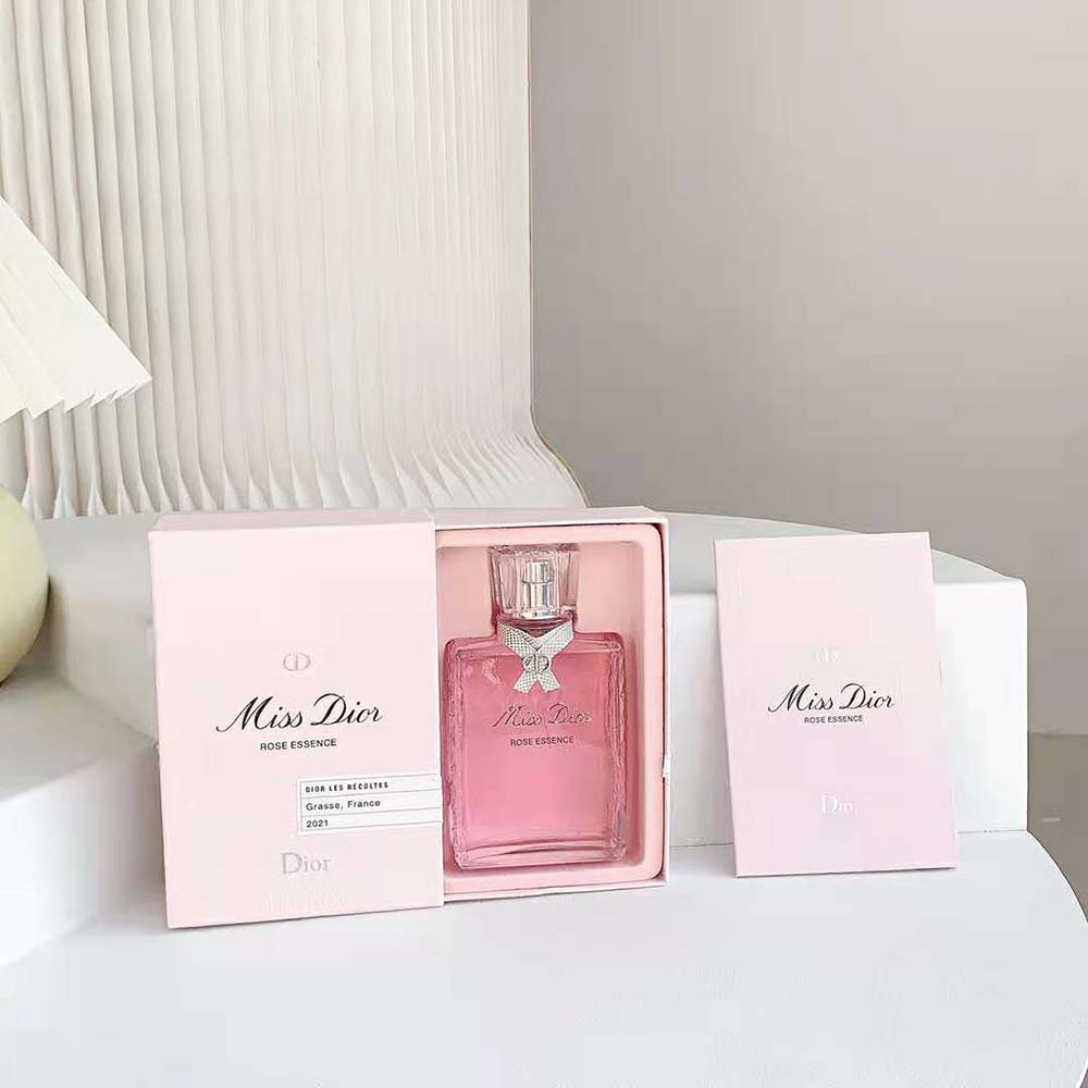 Close-up of silver cap and rose emblem on Miss Dior Rose Essence bottle