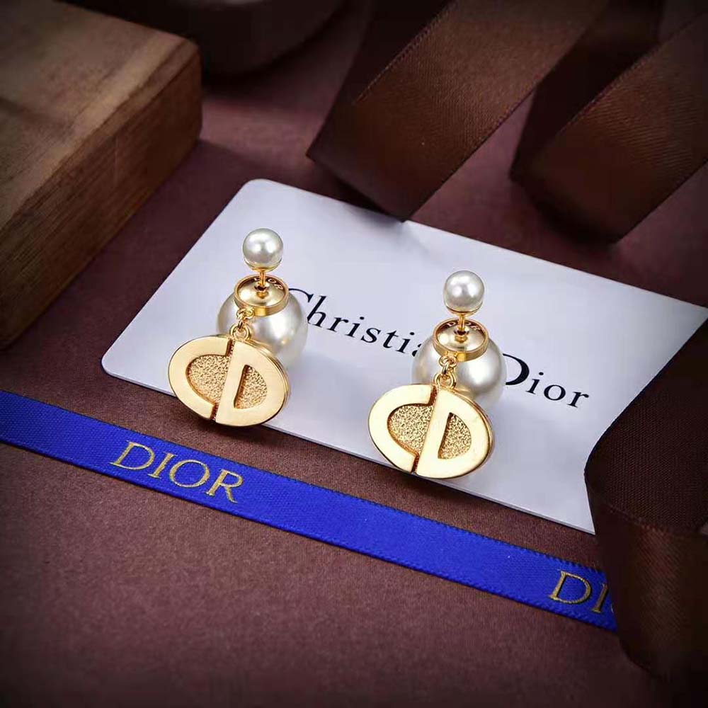 Lifestyle image showcasing Dior Women Tribales Earrings worn with elegant outfit