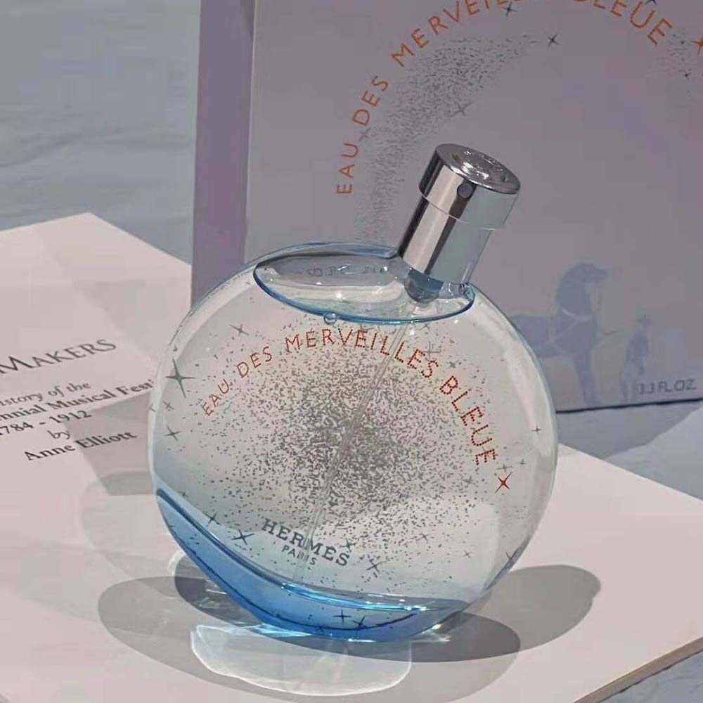 Close-up of blue glass and spray of Hermes Women Eau Des Merveilles Bleue