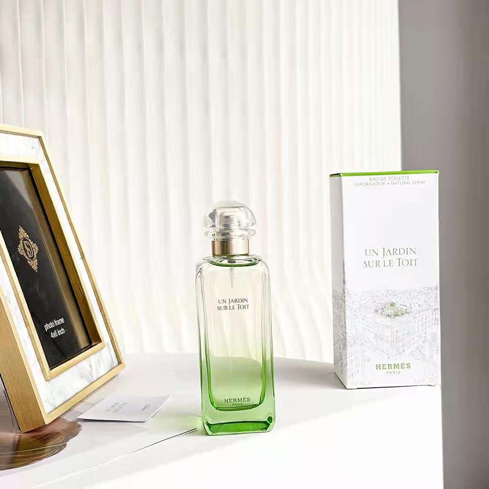 Close-up of spray nozzle and green glass detail on Hermes fragrance