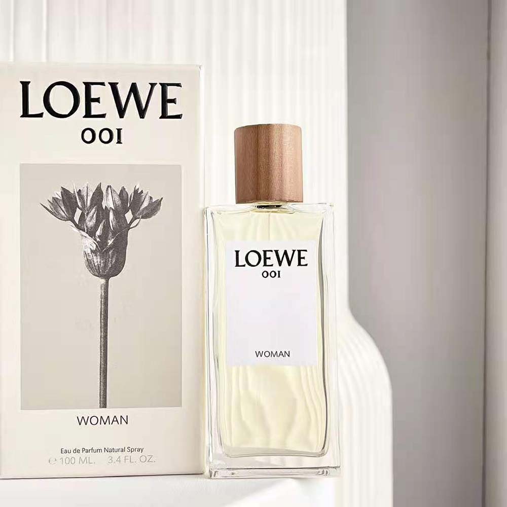 Close-up of silver cap and embossed detail on Loewe 001 Woman perfume