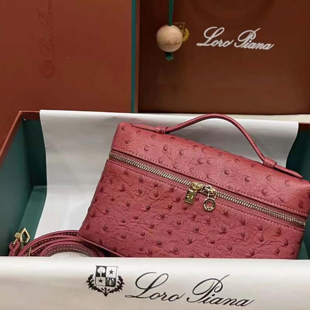 Side angle showing slim silhouette and flap closure of Loro Piana pouch