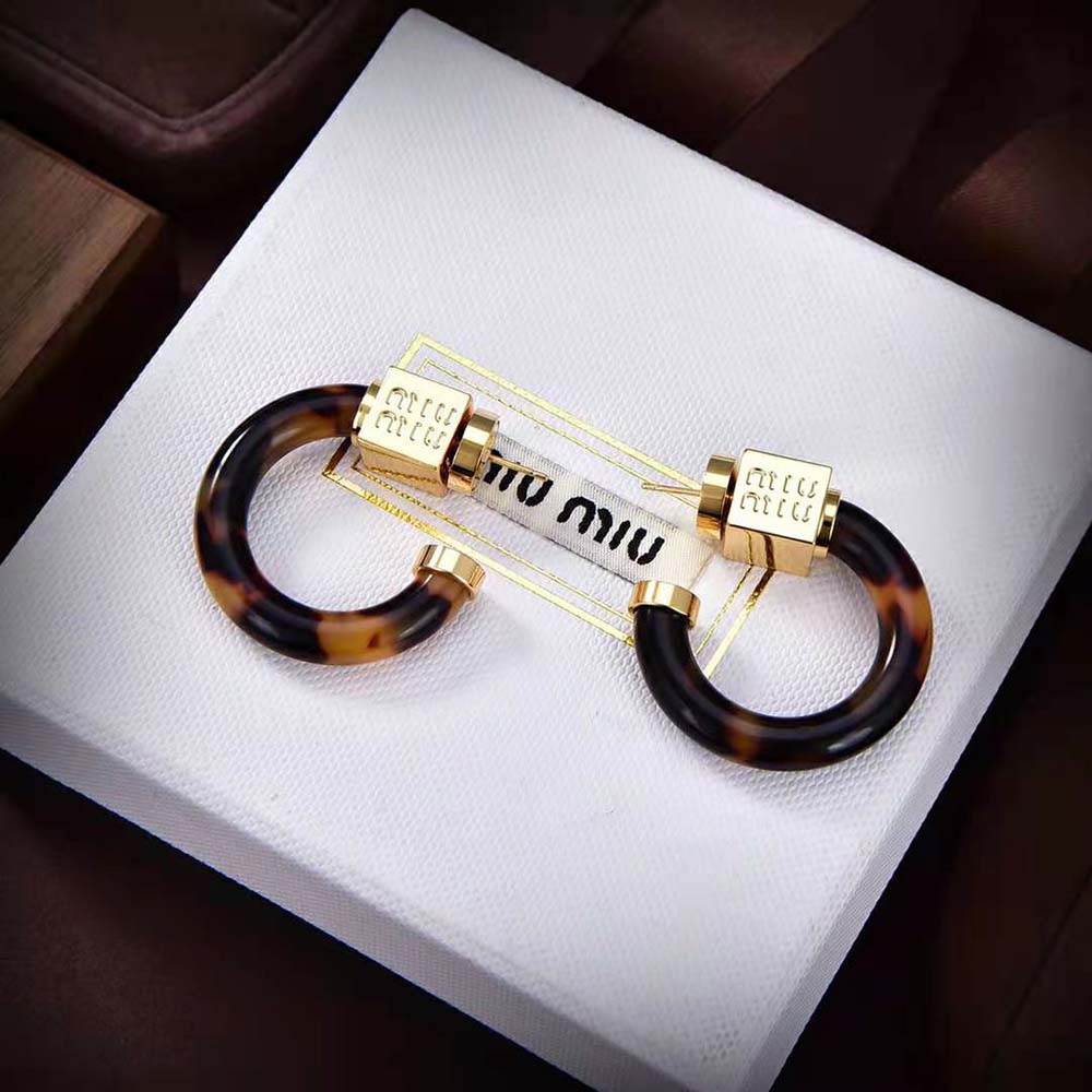 Close-up detail of gold-tone closure on Miu Miu Women Plexiglas Earrings