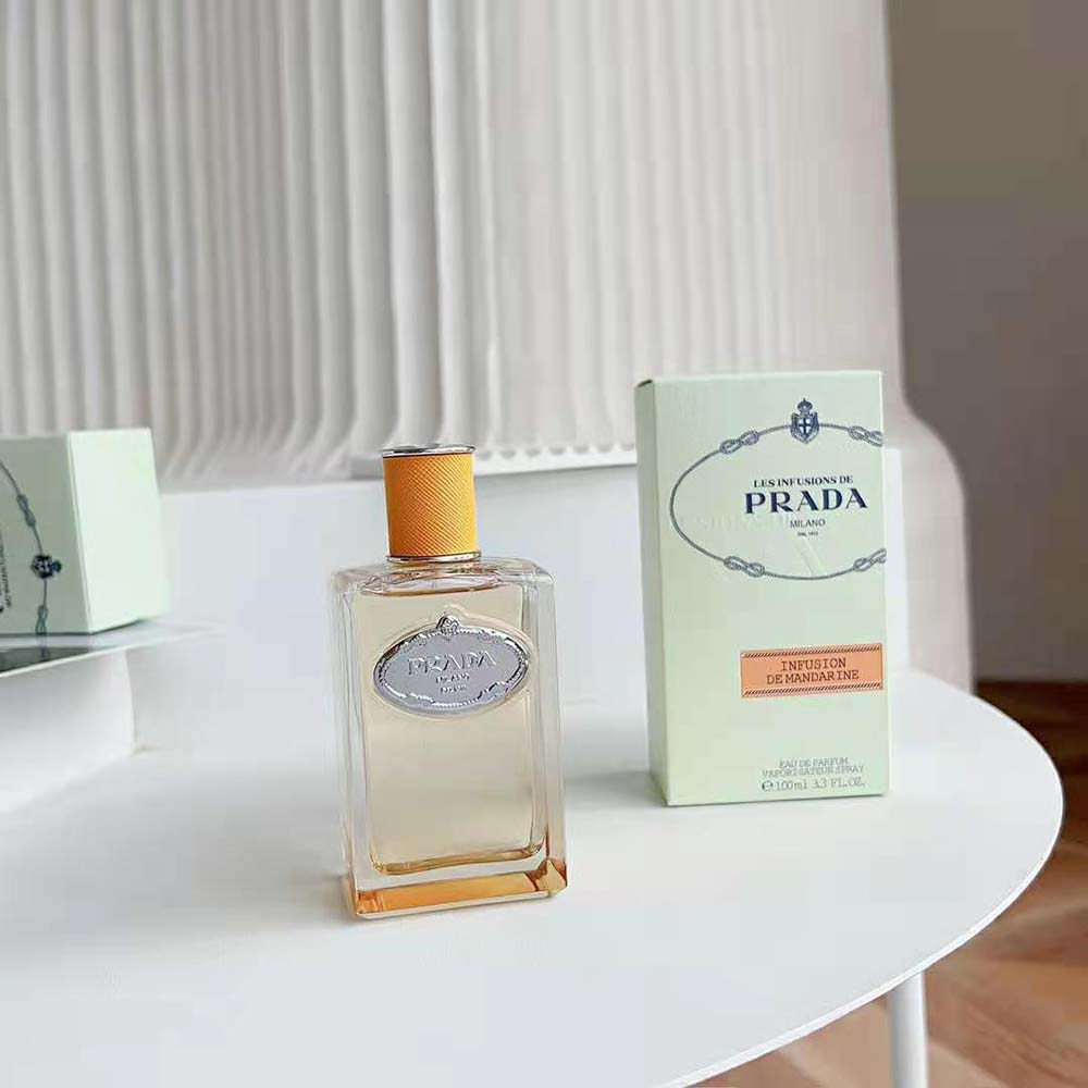 Close-up on orange glass and minimalist cap of Prada Unisex Infusion De Fleur D’Oranger