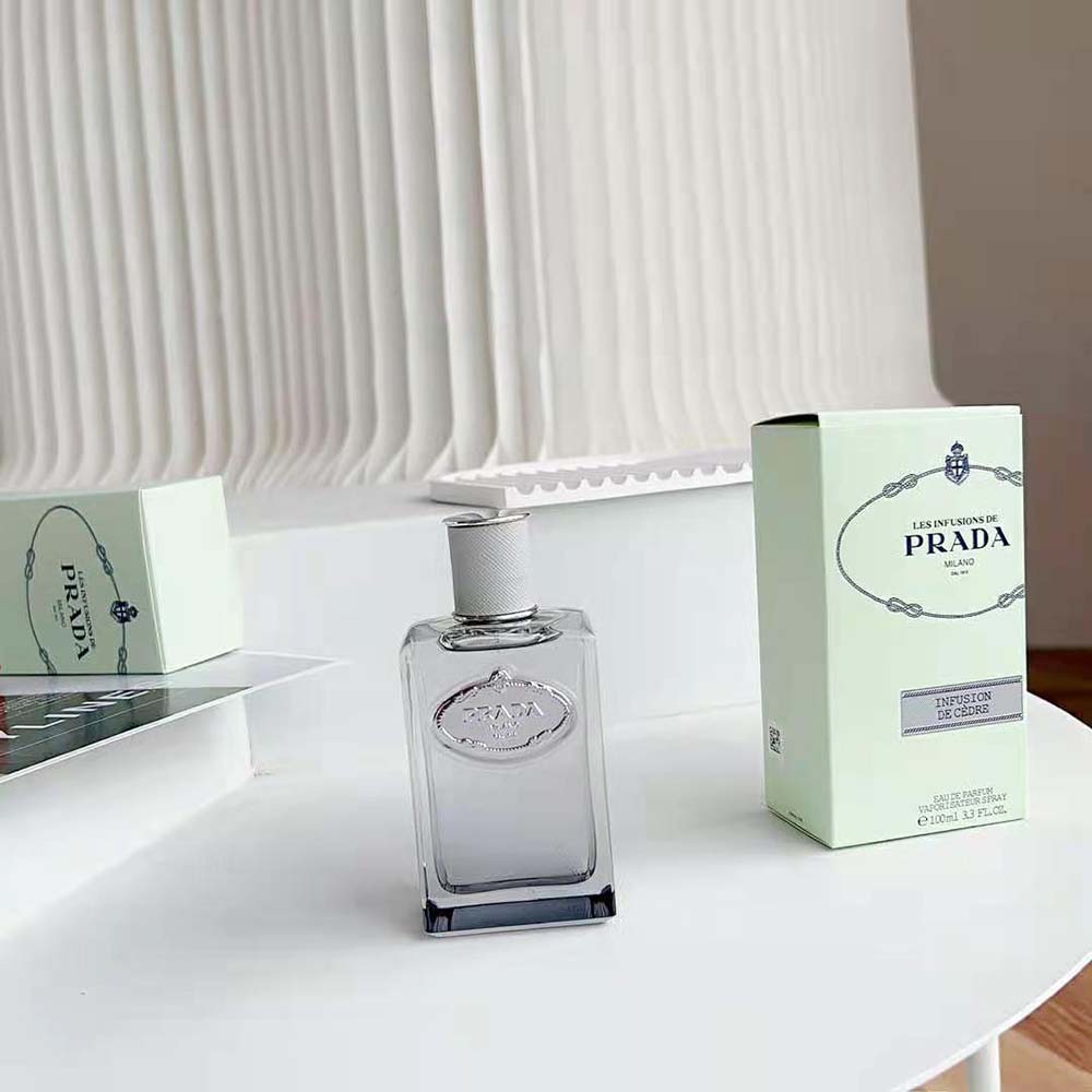 Side angle highlighting sleek glass and silver details of Prada Infusion de Cèdre