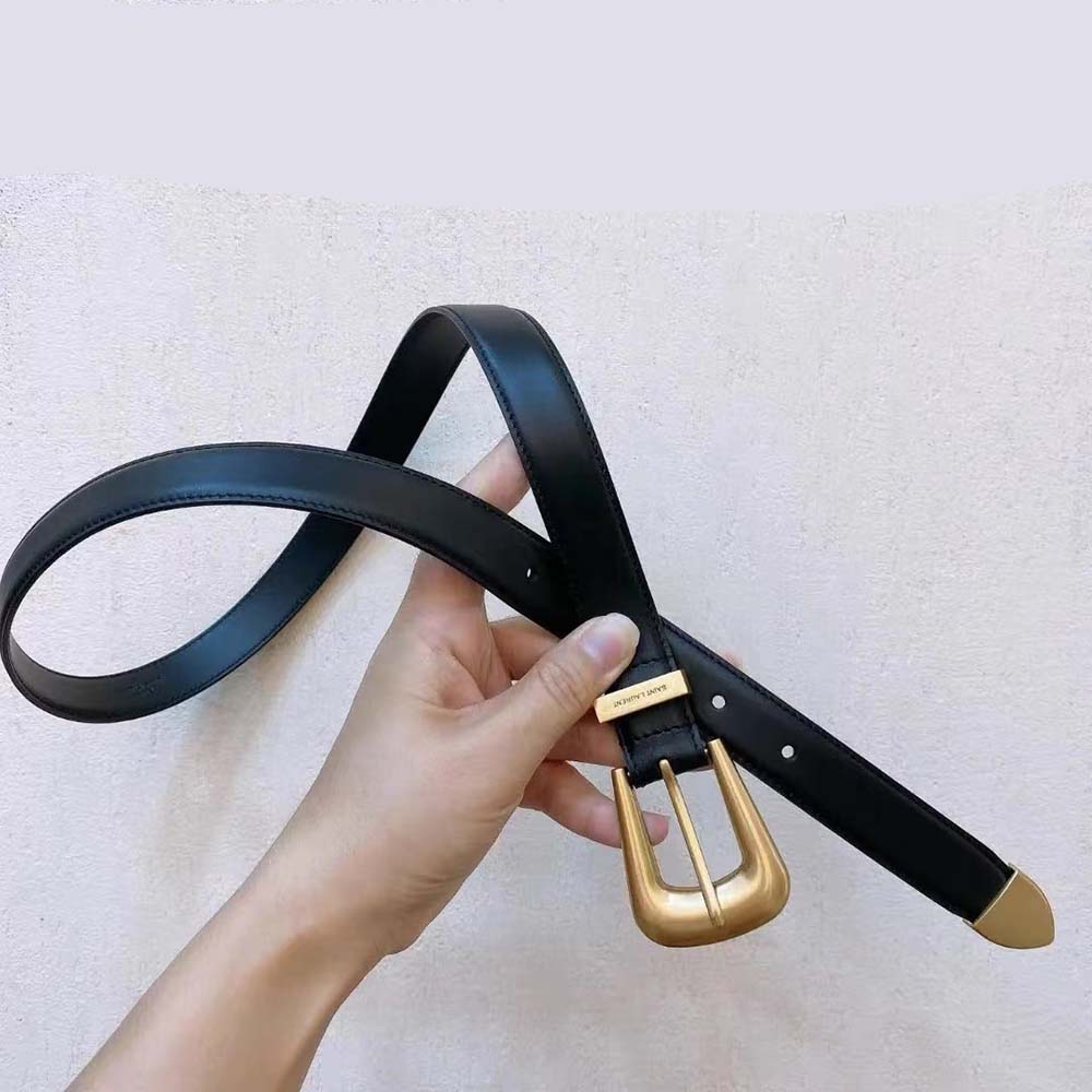 Close-up of YSL metal buckle on black brushed leather belt