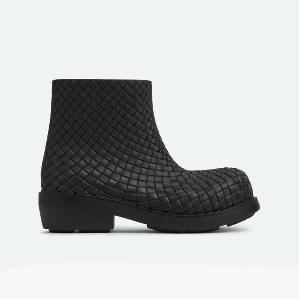 Side profile of Bottega Veneta Unisex Fireman Ankle Boot-Black showing lug sole