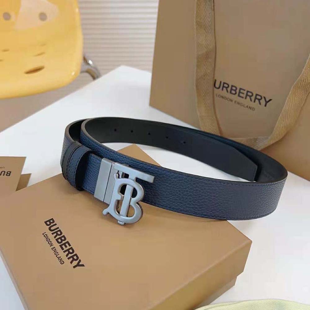 Close-up of navy leather texture and TB metal buckle on reversible belt