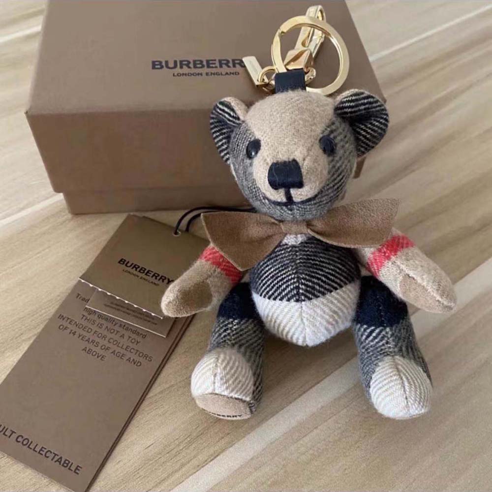 Close-up on polished metallic bow tie detail of Burberry Thomas Bear Charm