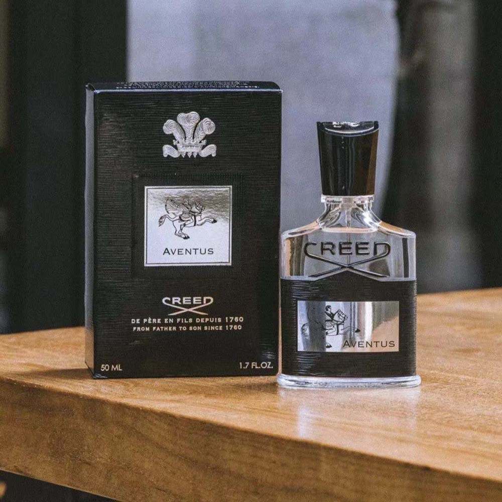 Close-up of sleek white bottle and minimalist cap of Creed Fragrance Men Aventus