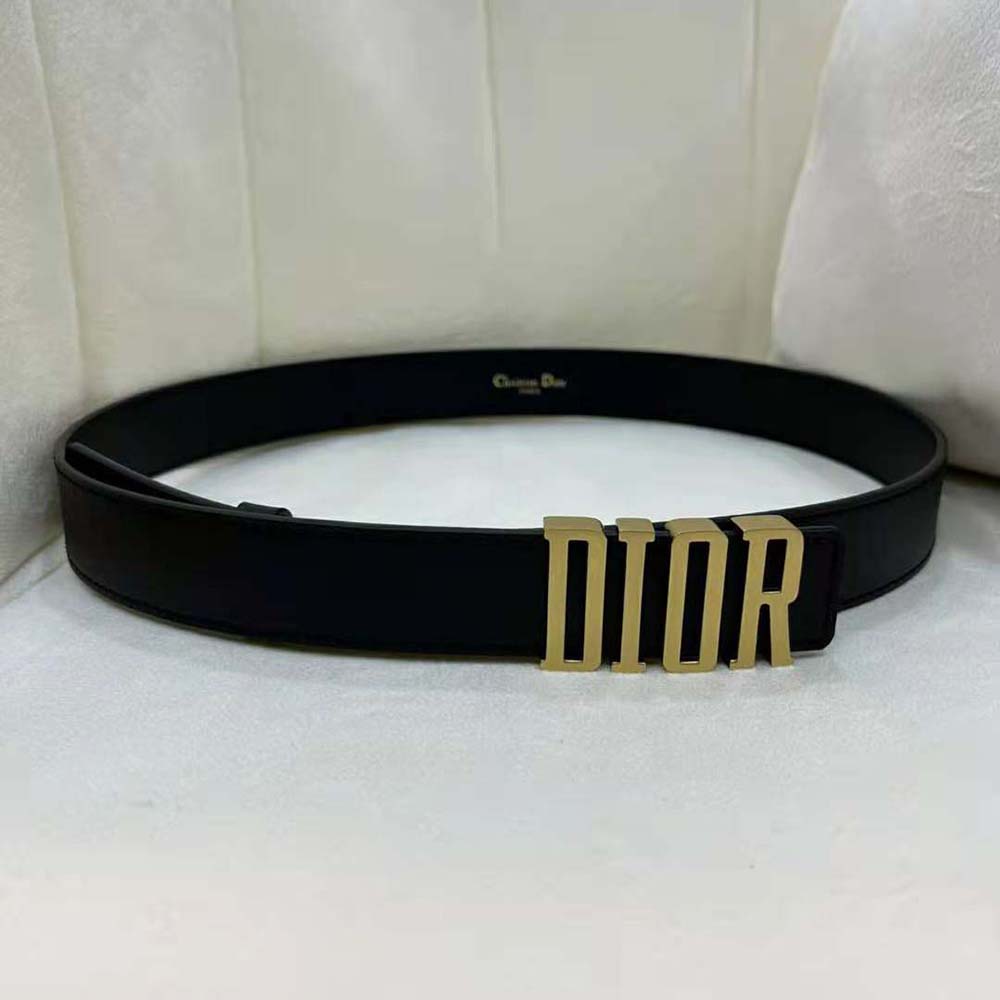 Close-up of polished Dior metallic closure on smooth black calfskin belt