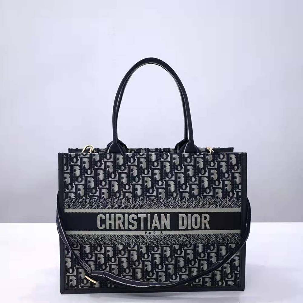 Close-up of blue Dior Oblique embroidery and calfskin texture on tote