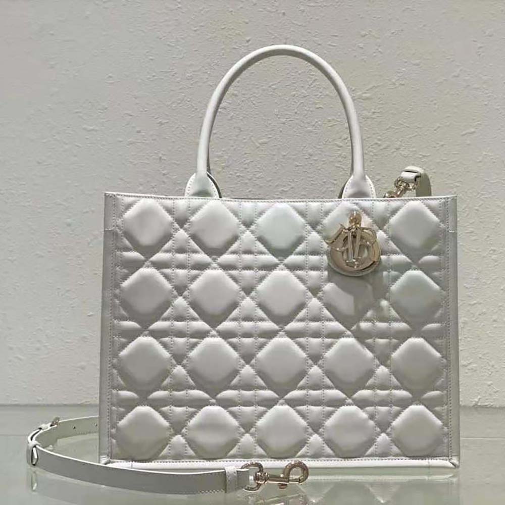 Close-up of white calfskin texture and macrocannage stitching on Dior tote