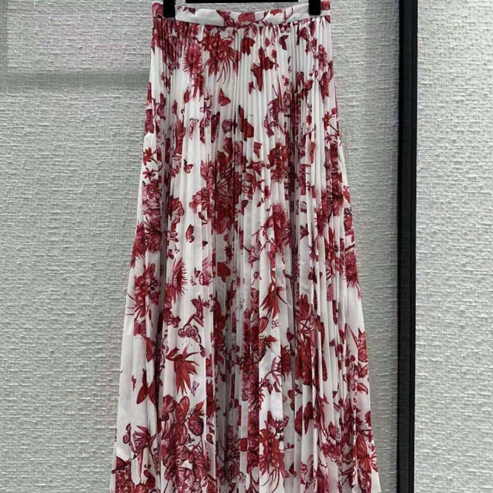 Close-up detail of red Toile de Jouy Mexico motif on Dior pleated skirt