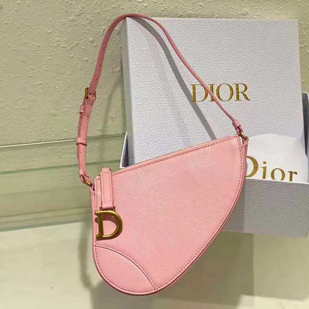 Close-up of gold Dior 'D' hardware on pink goatskin pouch