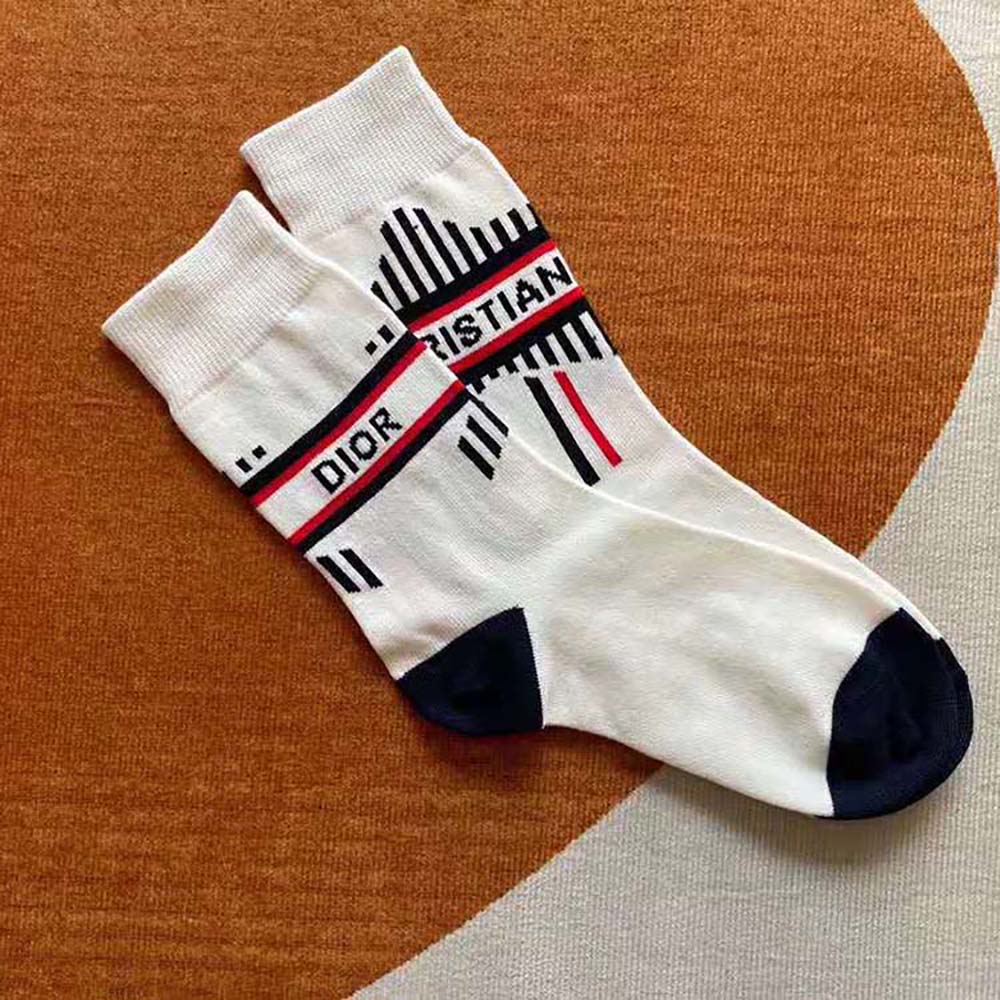 Close-up detail of Dior Oblique pattern on white and ecru socks