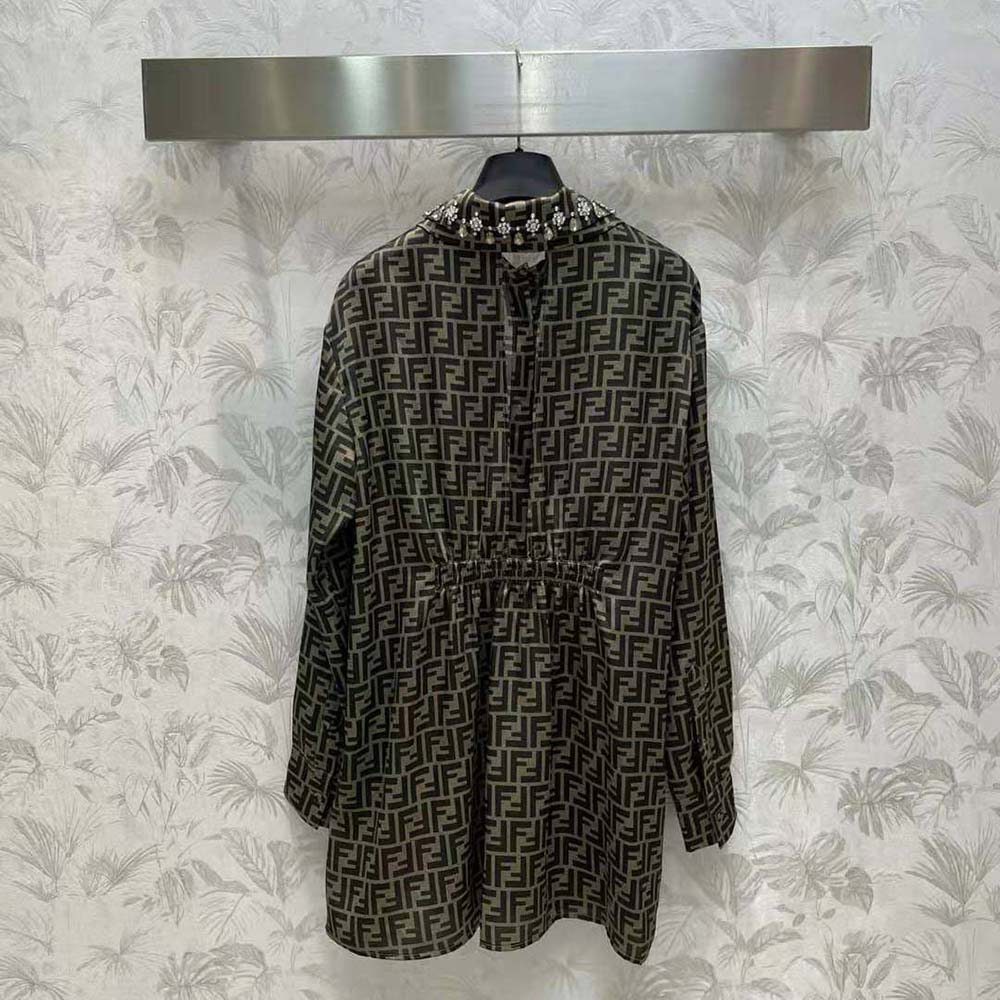 Close-up of Fendi logo buttons on brown FF twill shirt dress sleeve
