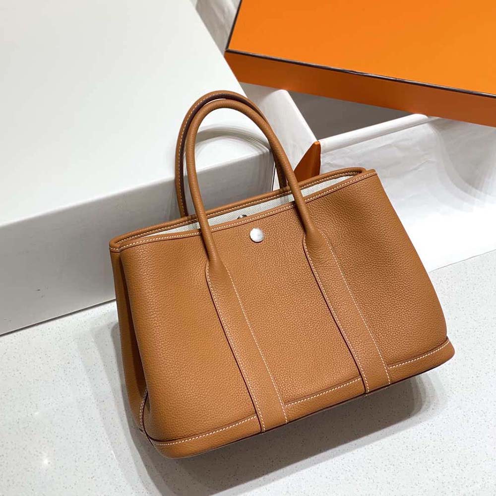 Close-up of brown leather texture and silver hardware detail