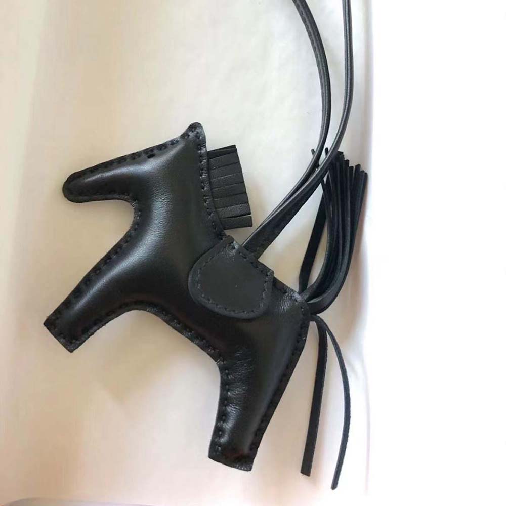 Side angle showing snap closure and silhouette of Hermes Unisex Rodeo MM Charm