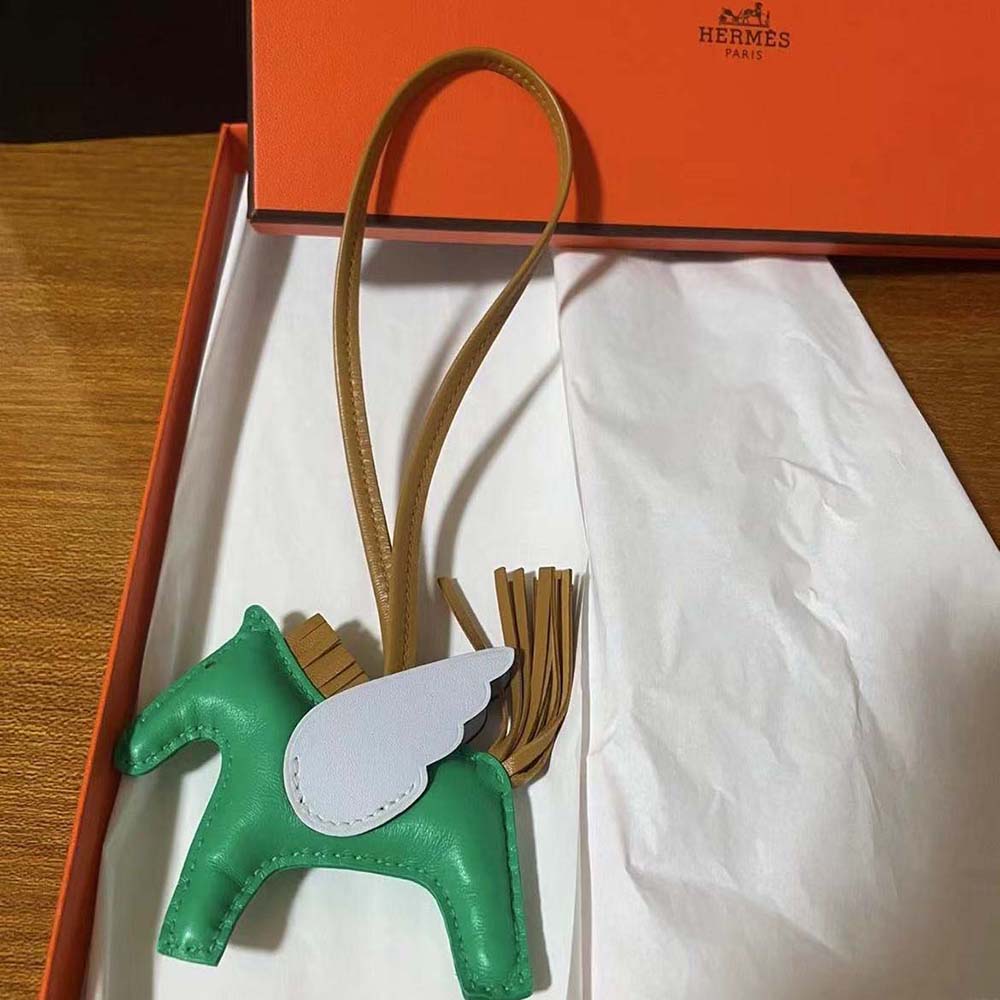 Side view of Hermes Unisex Rodeo Pegase MM Charm-Blue attached to bag handle