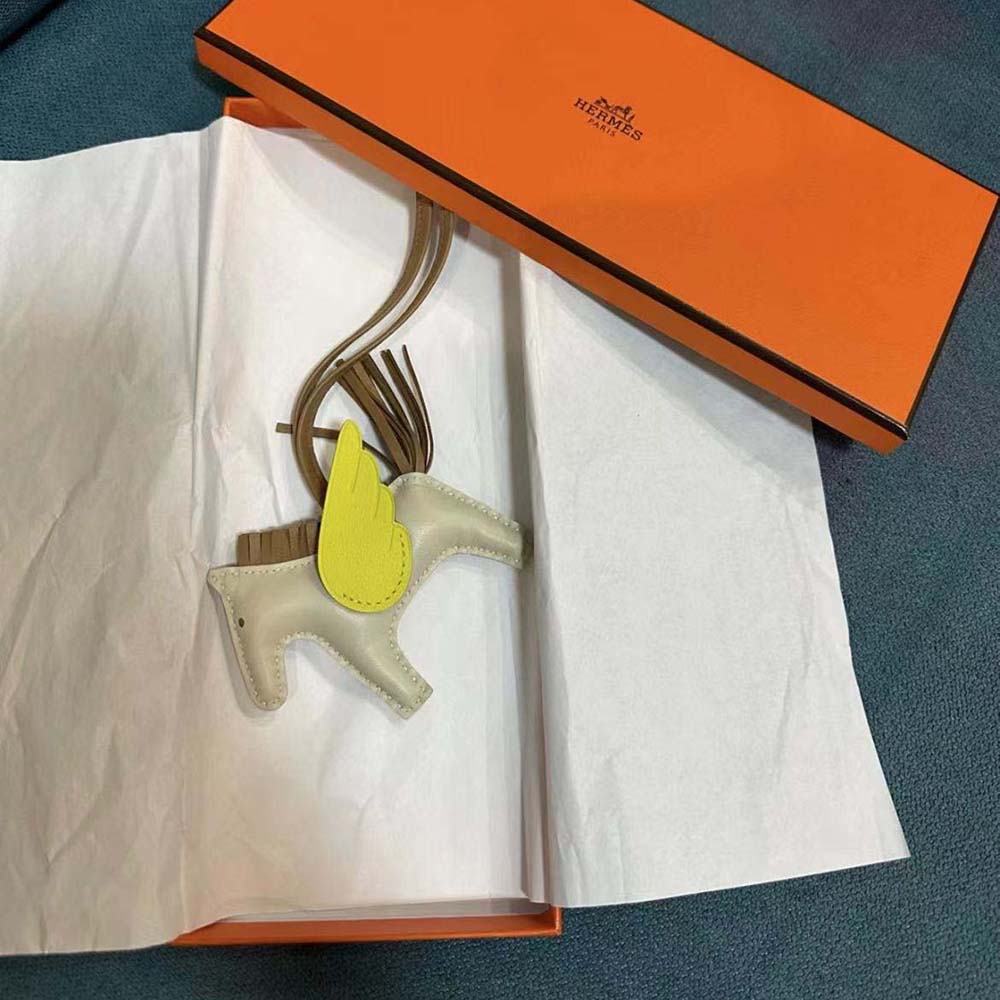 Side angle of Hermes Unisex Rodeo Pegase MM Charm-Yellow showing size
