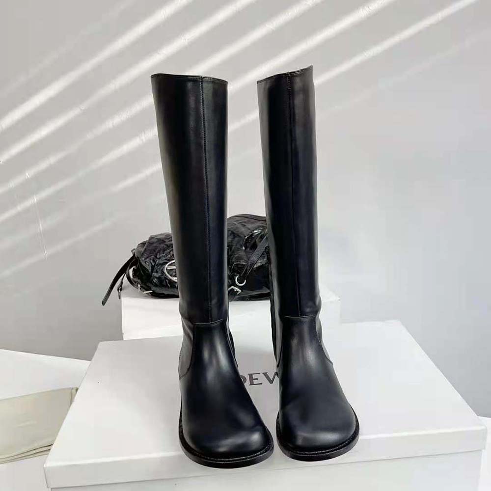 Close-up of black calfskin texture and lace-up detail on Loewe Women Campo Boot