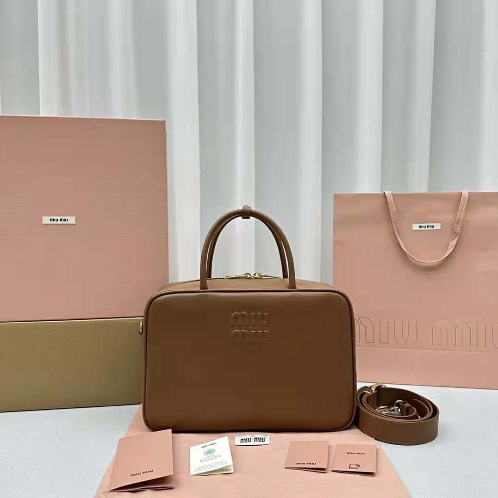 Close-up of embossed logo detail on Miu Miu Women Leather Top-handle Bag