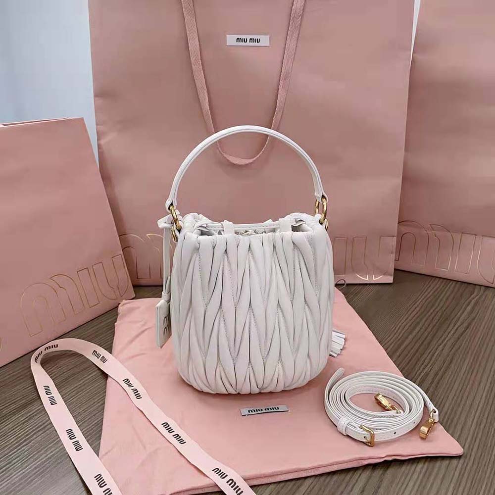 Side angle showing adjustable shoulder strap on Miu Miu Women Matelassé Nappa Leather Bucket Bag-White
