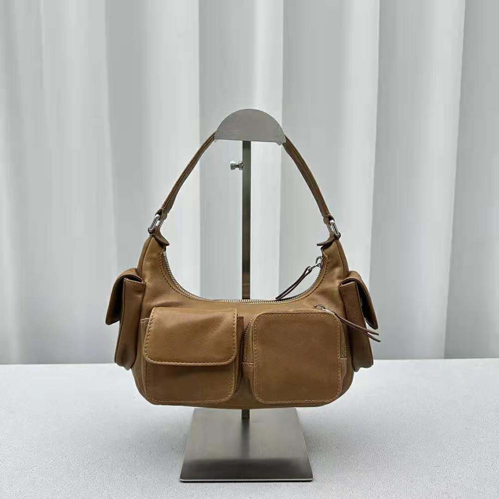 Side angle showing gold closure and brown leather of Miu Miu Women Pocket Nappa Leather Bag