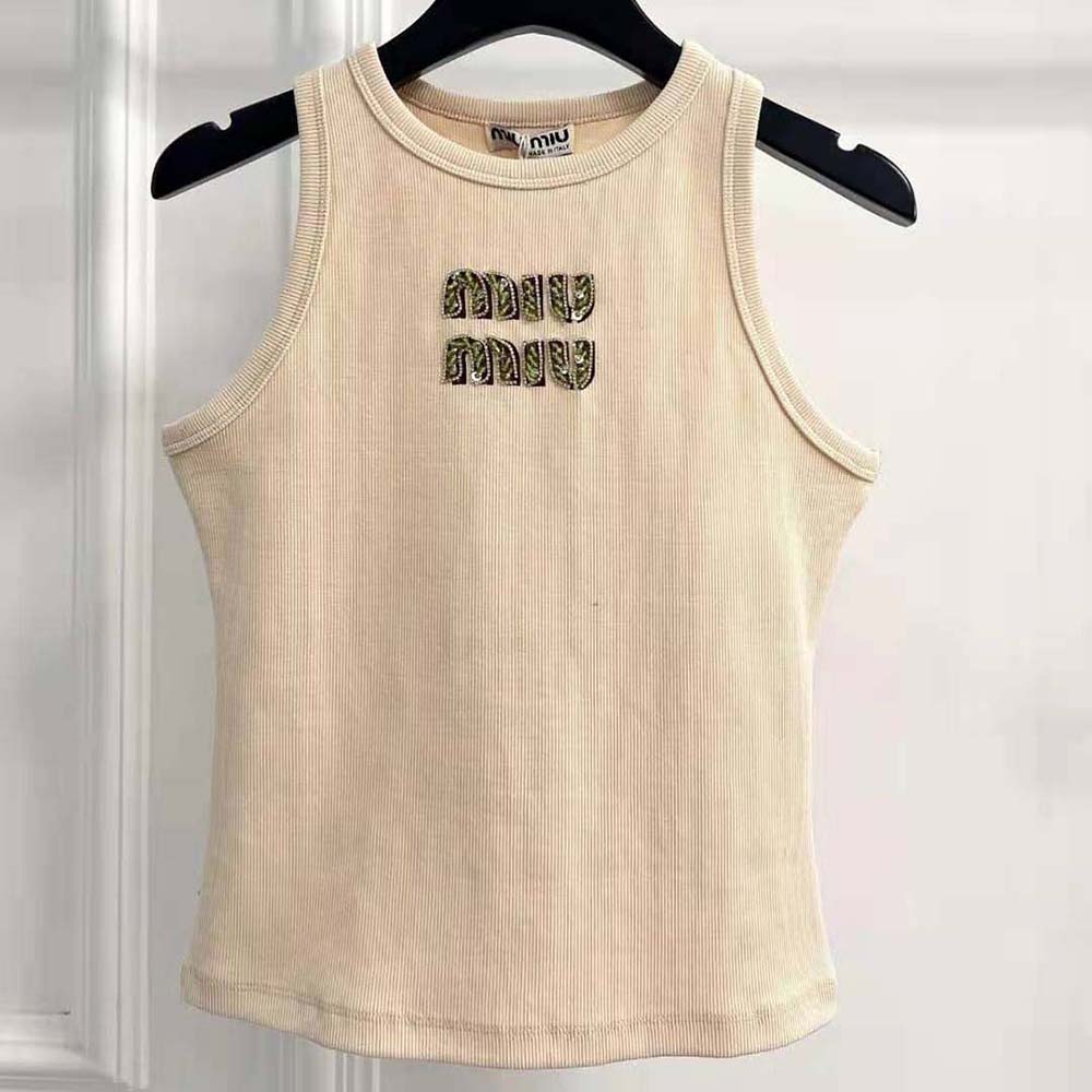 Close-up detail of embroidered logo on beige Miu Miu ribbed jersey top