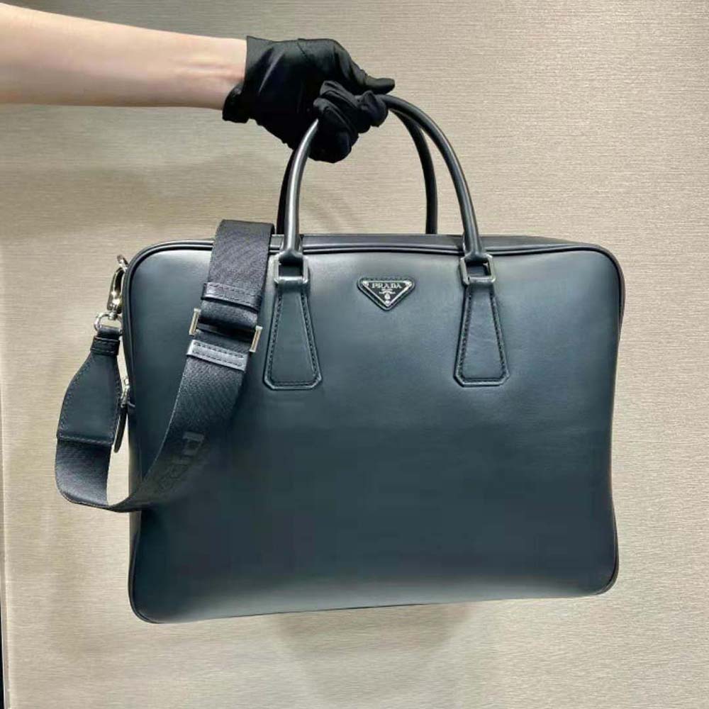 Close-up of black calfskin leather and Prada enameled metal logo detail