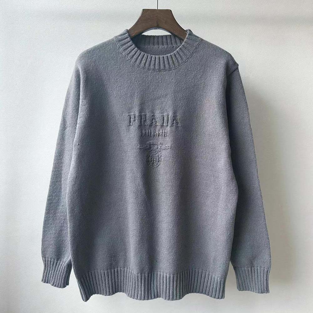 Close-up of silver fabric texture on Prada crew-neck sweater