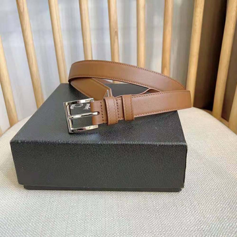 Close-up of enameled-metal triangle logo on Prada Unisex N Leather Belt
