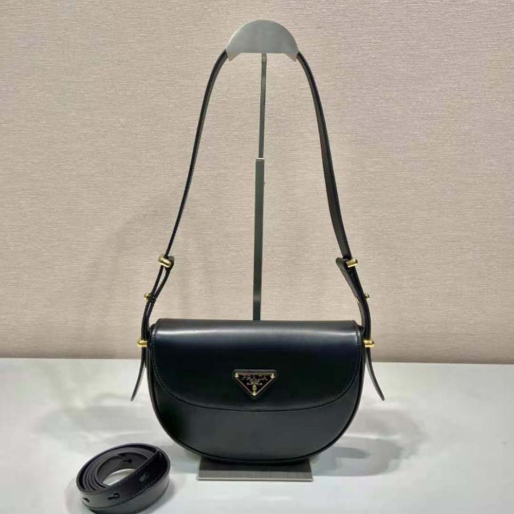 Close-up on silver Prada hardware on black leather flap bag