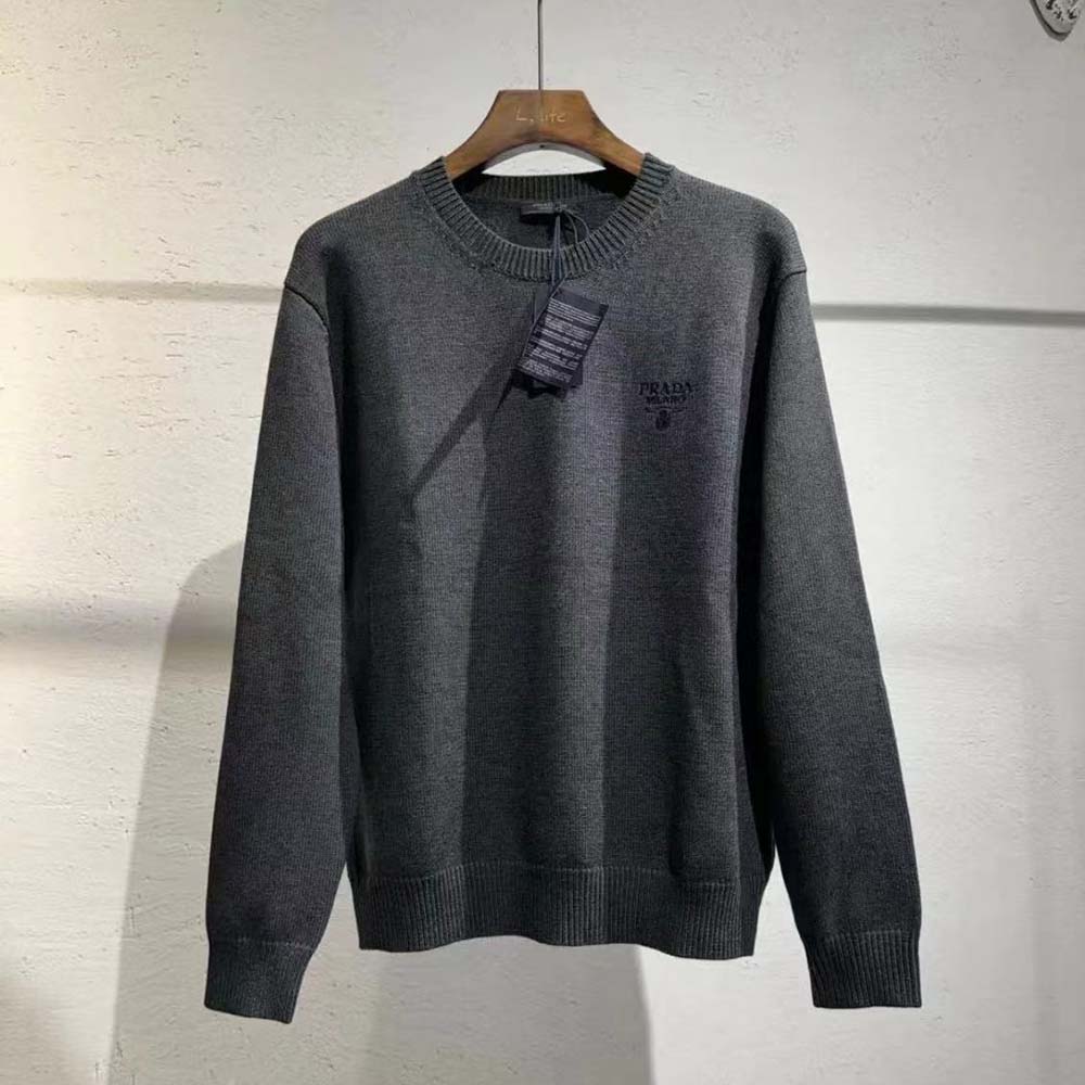 Close-up of embroidered Prada logo on gray cashmere sweater