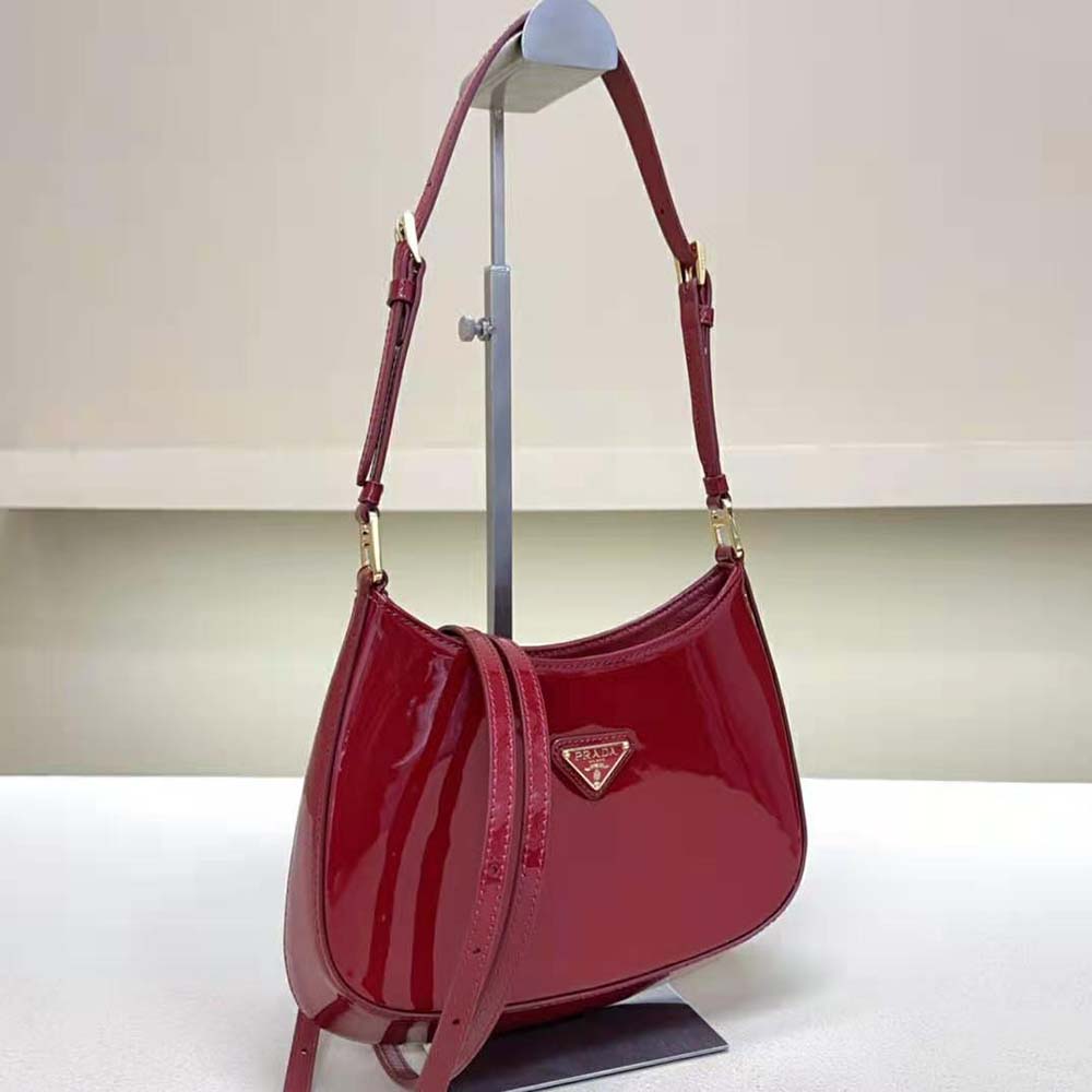 Side angle highlighting curved silhouette of Prada Women Cleo Patent Leather Bag-Red