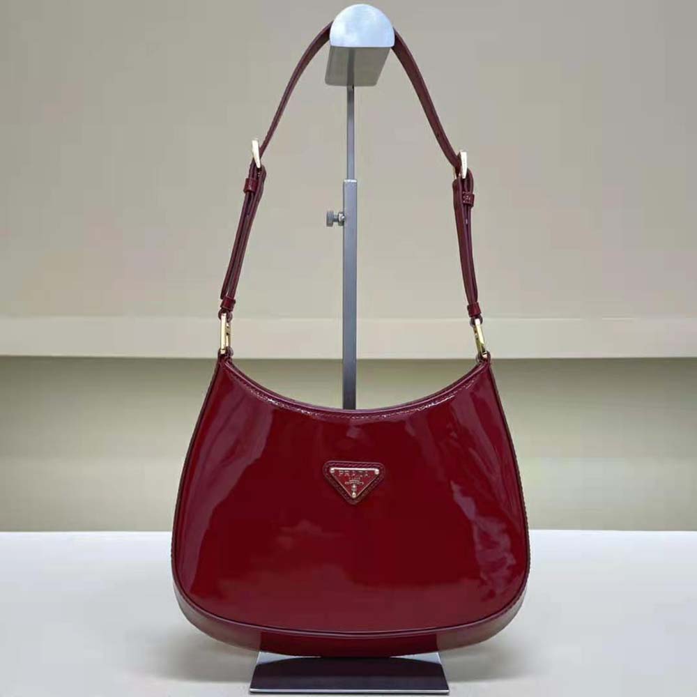 Close-up of gold Prada logo plaque on Prada Women Cleo Patent Leather Bag-Red