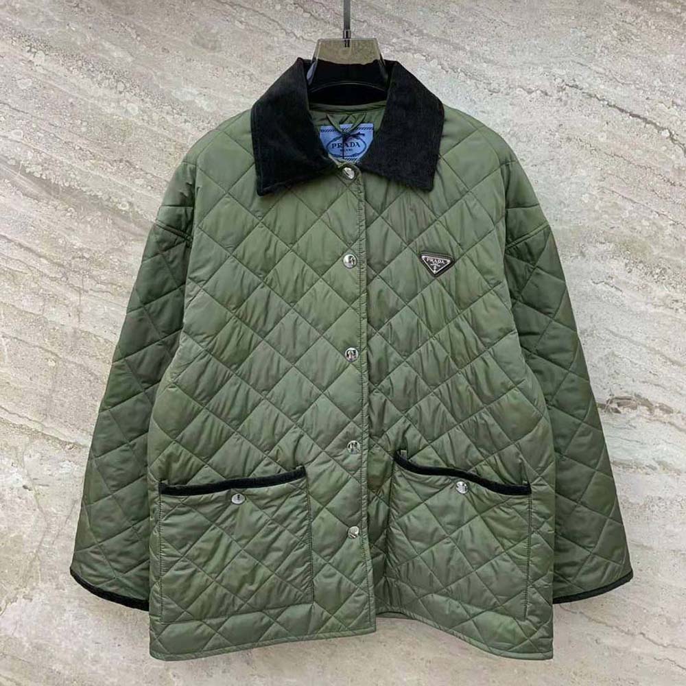 Close-up of enameled metal triangle logo on Prada Women Light Re-Nylon Jacket